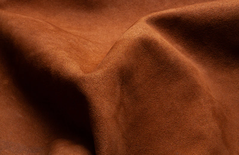 Folds of rich brown suede leather